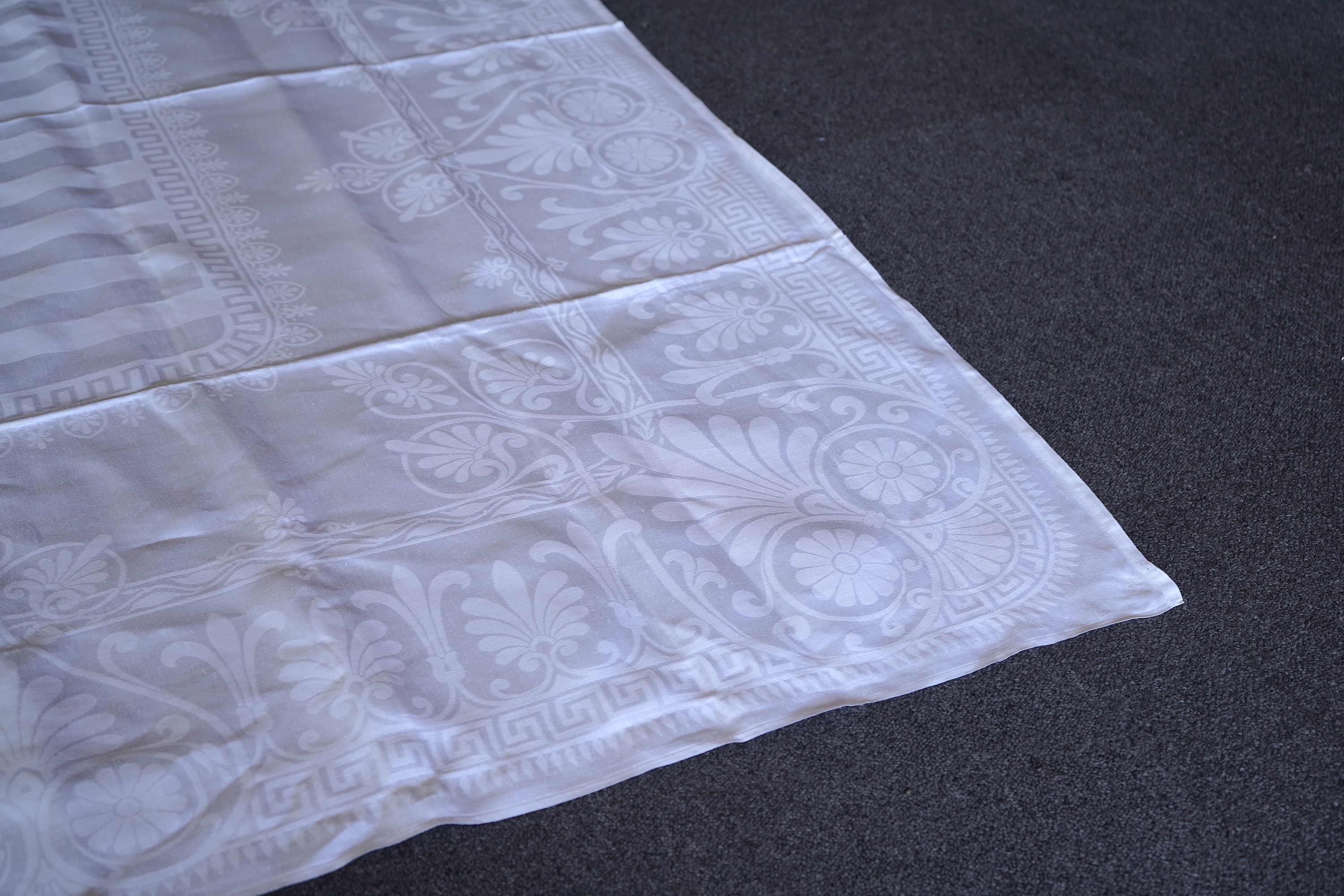A late 19th century large white Irish damask table cloth, woven with an all over Christopher Dresser ‘inspired’ design. The overall design incorporating many of his known stylistic design motifs. Each corner has a shamro
